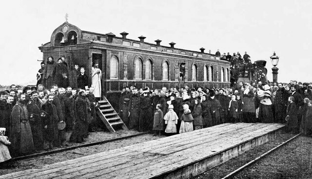 Pilgrims near the train car